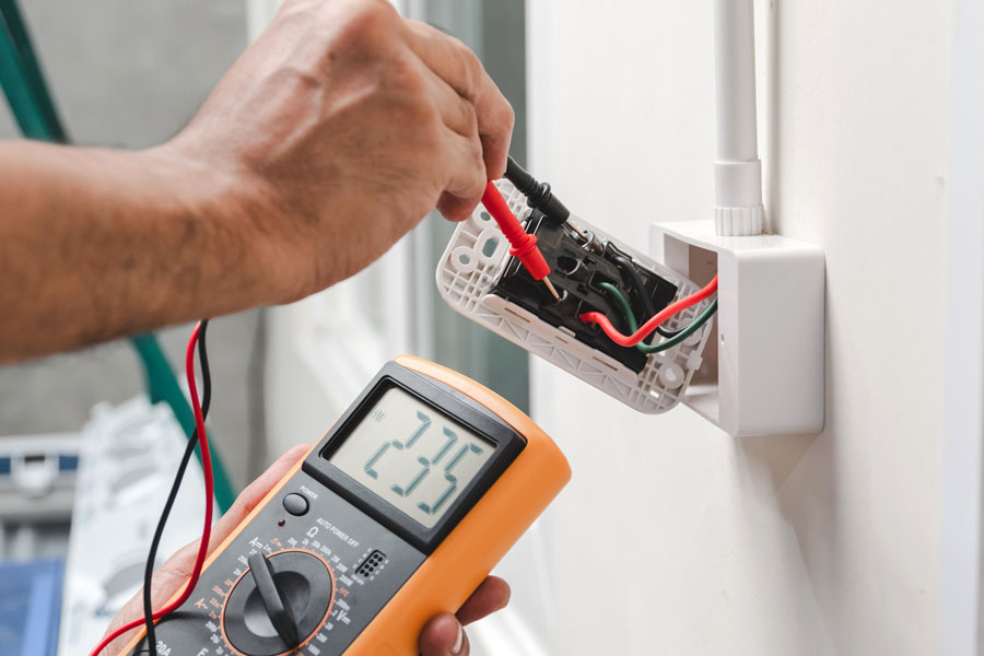 Electrician is using a digital meter