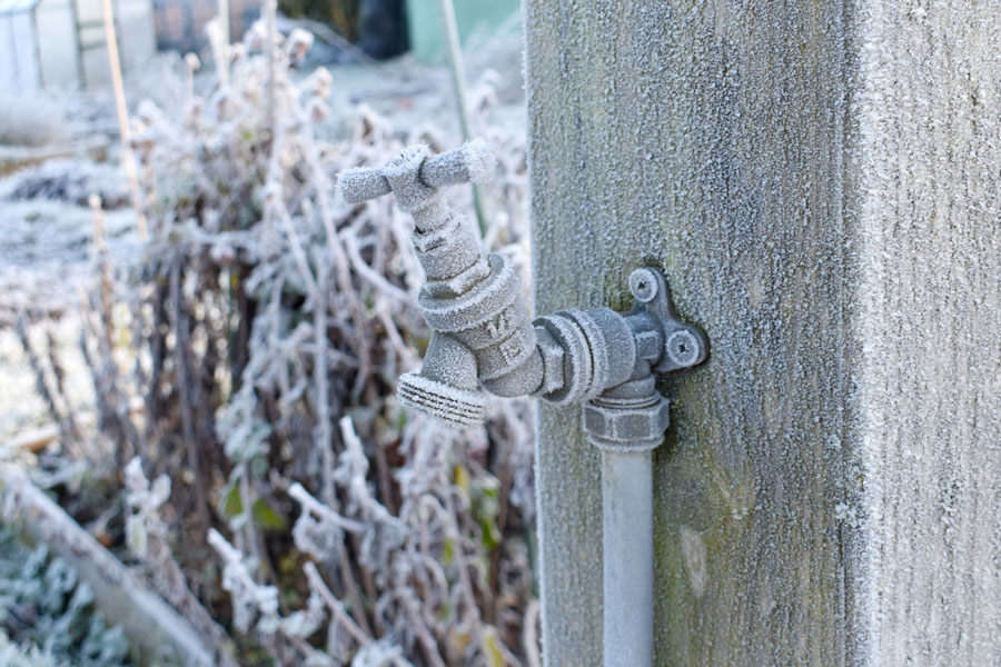 close up of outdoor water tap covered in frost
