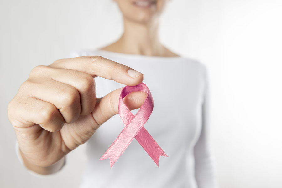 Hands holding pink awareness ribbon